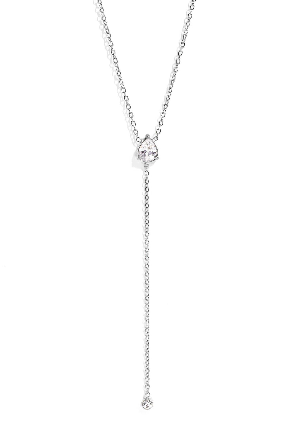 A delicate silver Y-necklace featuring a small heart-shaped crystal pendant and a long drop chain ending in a single clear crystal bead, shown against a solid white background.