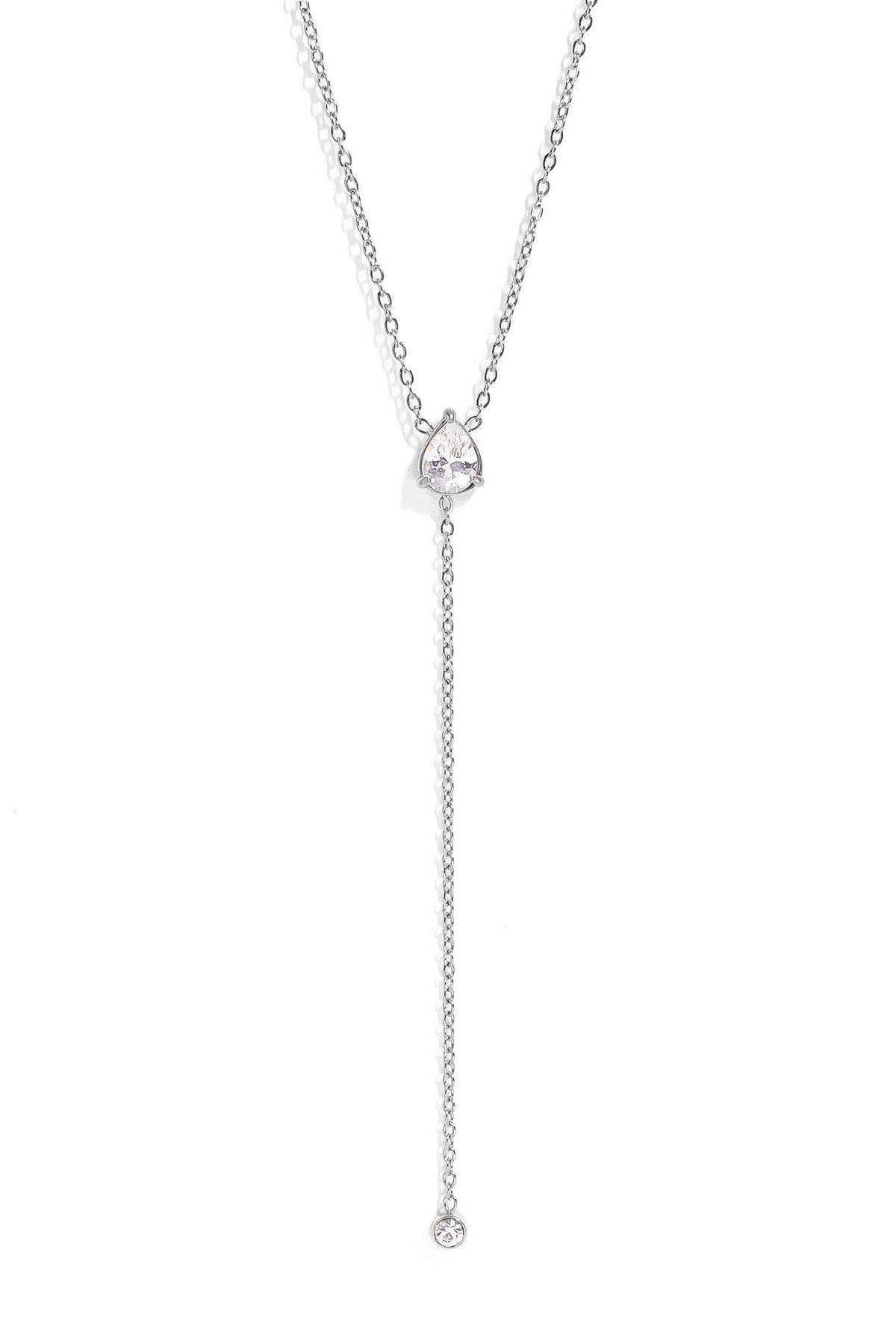 A delicate silver Y-necklace featuring a small heart-shaped crystal pendant and a long drop chain ending in a single clear crystal bead, shown against a solid white background.