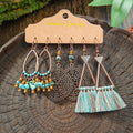 Pair of tassel earrings on a wooden display card with a natural background