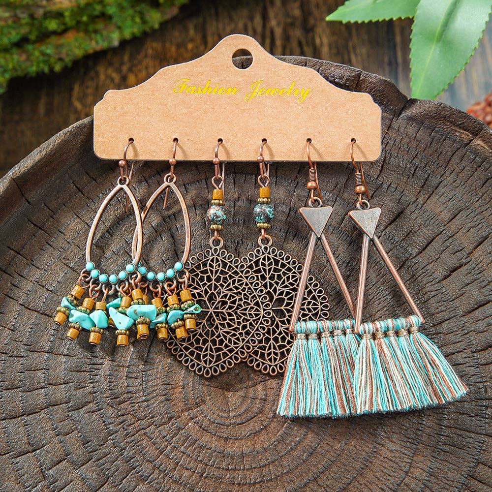 Pair of tassel earrings on a wooden display card with a natural background