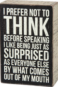 Wooden box with black and white text on a wooden surface