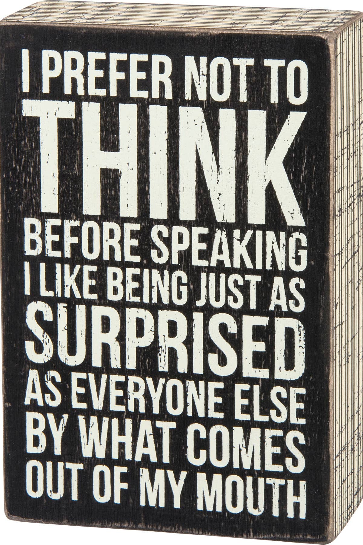 Wooden box with black and white text on a wooden surface