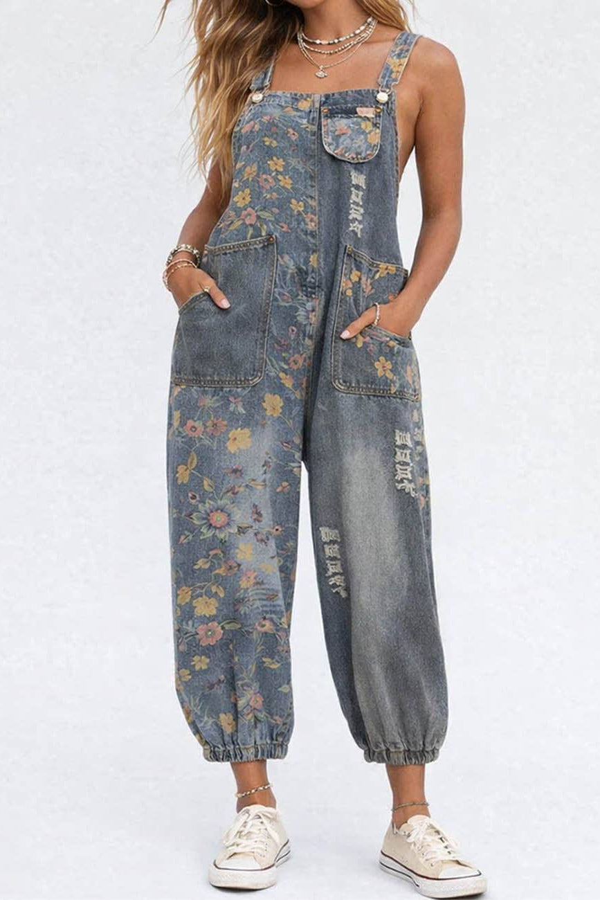 Person wearing floral denim overalls on a white background