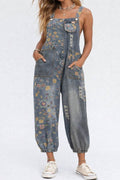 Person wearing floral denim overalls on a white background