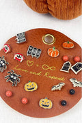 Collection of Halloween-themed pins on a decorative board with a pumpkin design.