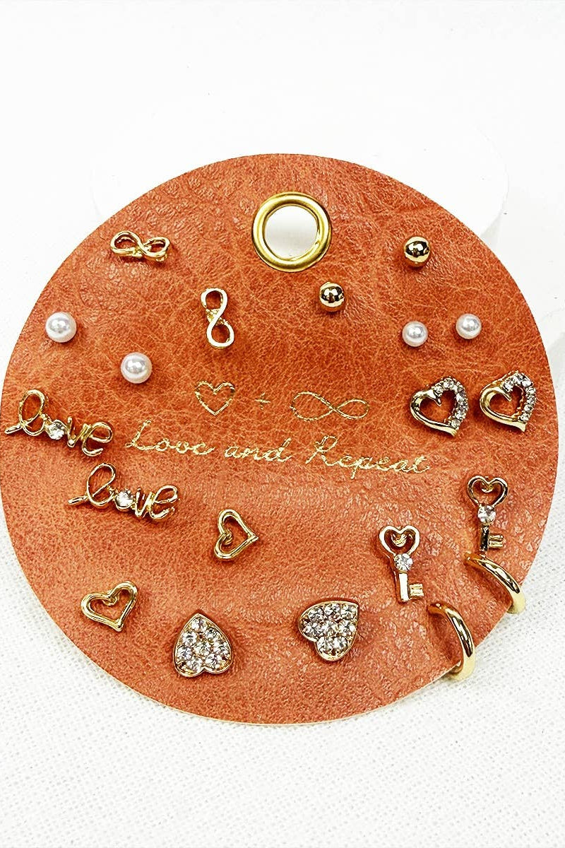 Collection of gold and pearl earrings on a round leather card with 'Love' and 'Pearl' text.